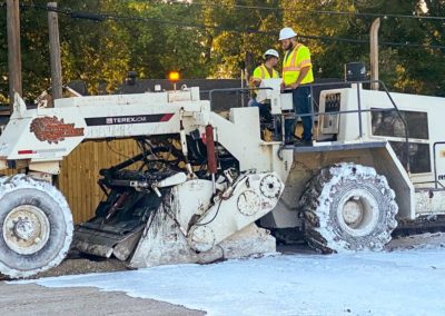 Soil compactor processing liquid stabilization compounds with soil during a soil stabilization project.